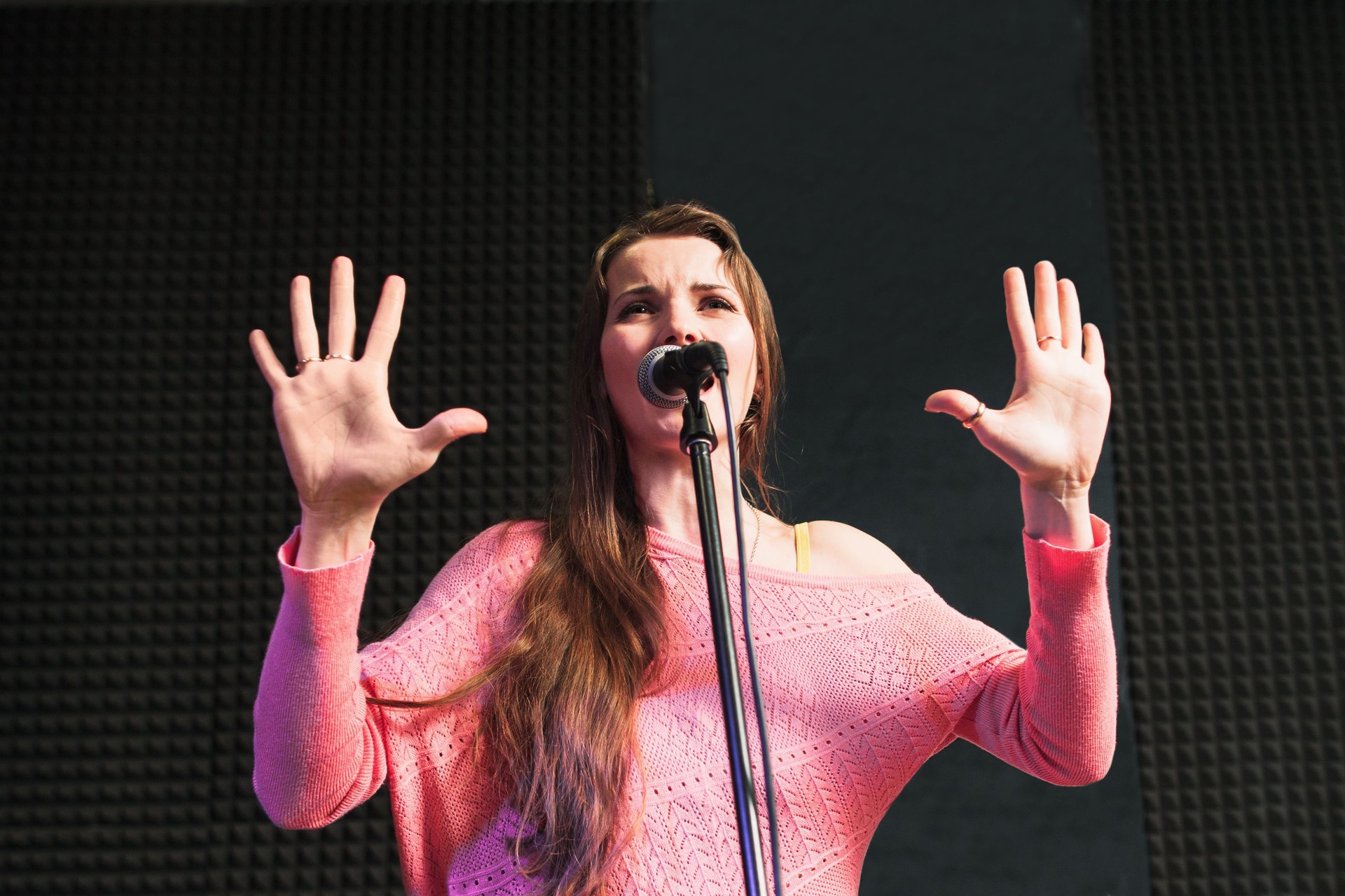 Women performing against the microphone